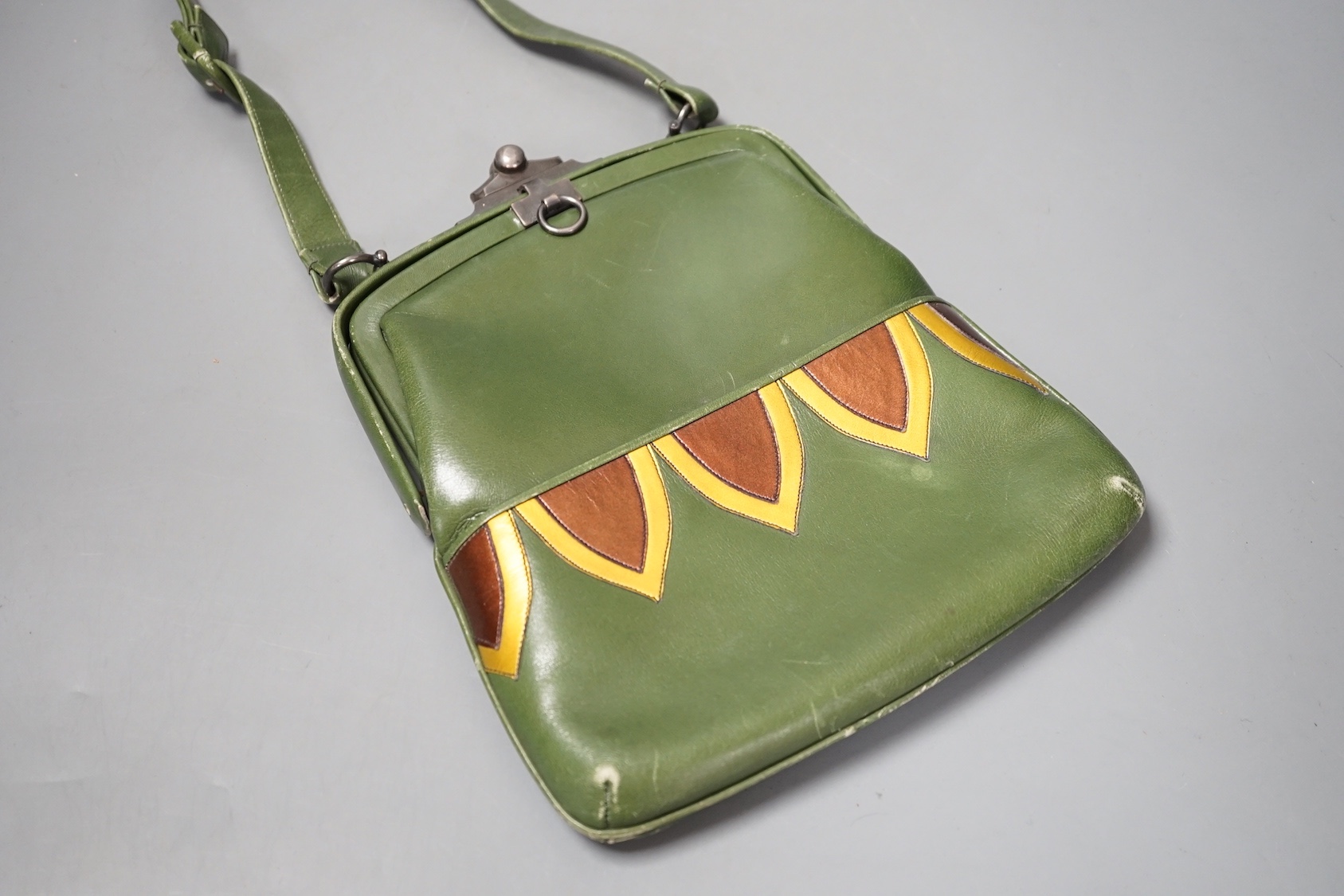 An unusual Art Deco green, brown and yellow leather handbag, 24 cms high (including clasp) x 20 cms wide.